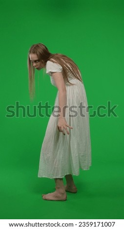 Full-size half turn vertical green screen, chroma key shot of a posessed female, woman figure, ghost, poltergeist, zombie turning her face to the camera.