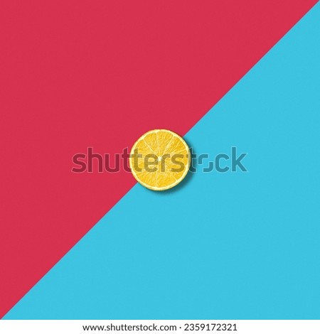 Minimalist abstract illustration with single lemon slice on vibrant red and turquoise background
