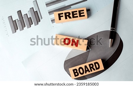 FREE ON BOARD wooden block on a chart background