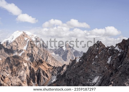Sharp and snow-capped mountain peaks in Tajikistan. High quality photo