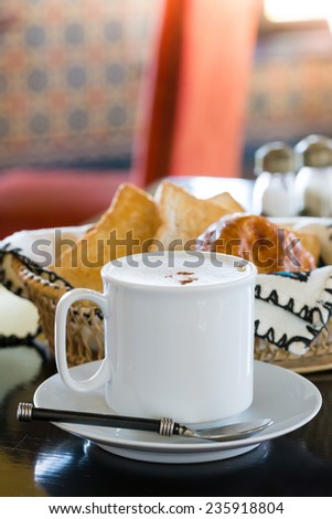 Hot Coffee with Bread in background