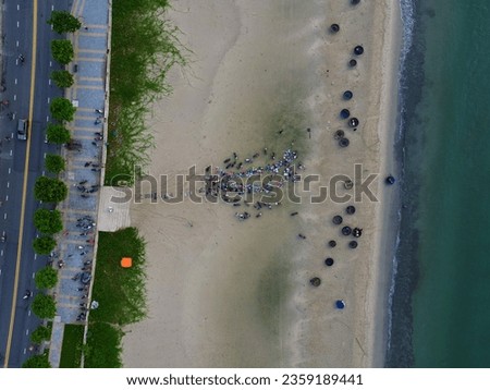 Aerial view of beach with basket boats and outdoor seafood market in Da Nang, Vietnam in the morning.  Travel concept, background.