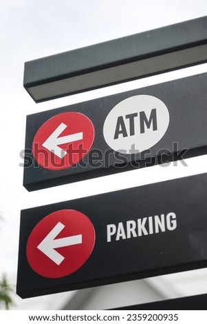 ATM banking direciton signboard with arrow and icon symbol. Transportation symbol object photo. Selective focus.