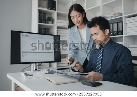 Two people looking at datasheets of marketing and sales results, analysis of business results jointly between executives, department heads and employees to brainstorm company sales management. Royalty-Free Stock Photo #2359229935