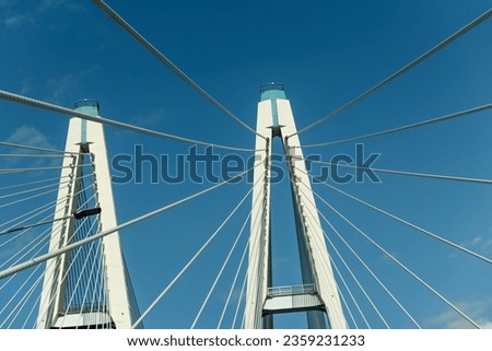 Cable-stayed bridge pylons against the blue sky Royalty-Free Stock Photo #2359231233