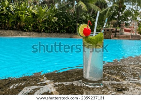 Mezcal-tequila cocktail by a swimming pool