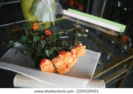 Beautiful young florist in flower shop.