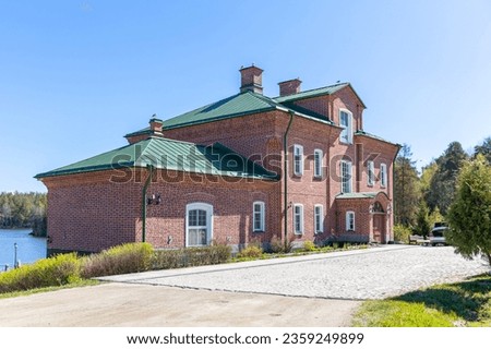 A beautiful brick building against the blue sky. Landscape. Spring sunny day