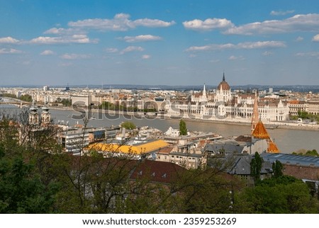 A picture of some Budapest landmarks, such as the Hungarian Parliament Building, the Szilagyi Dezso Square Reformed Church and the Saint Anne Parish Church siding the Danube river.