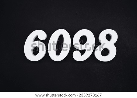 Black for the background. The number 6098 is made of white painted wood.