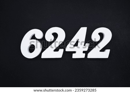 Black for the background. The number 6242 is made of white painted wood.