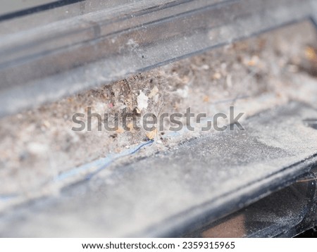 a dust container collected by a robot vacuum cleaner Royalty-Free Stock Photo #2359315965