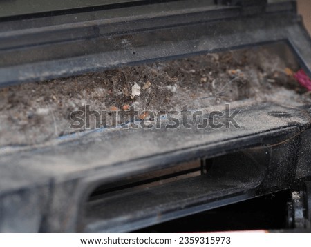 a dust container collected by a robot vacuum cleaner Royalty-Free Stock Photo #2359315973