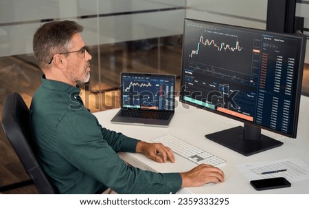 Busy middle aged older business man financial investor, stock trader broker analyzing online finance digital market thinking of investment strategy in crypto trading exchange platform using computer. Royalty-Free Stock Photo #2359333295