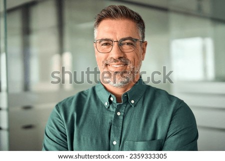 Smiling 45 years old banker, happy middle aged business man bank manager, mid adult professional businessman ceo executive in office, older mature entrepreneur wearing glasses, headshot portrait. Royalty-Free Stock Photo #2359333305