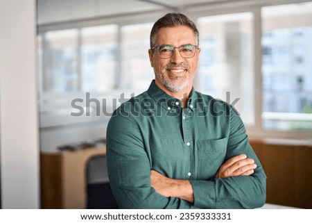Smiling older bank manager or investor, happy middle aged business man boss ceo, confident mid adult professional businessman executive standing in office, mature entrepreneur headshot portrait. Royalty-Free Stock Photo #2359333331
