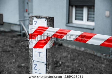 Red and White Lines of barrier tape. at street background. Red White warning tape pole fencing is protects for No entry Royalty-Free Stock Photo #2359335051