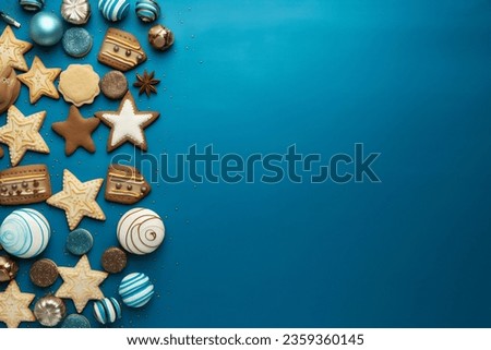 Hanukkah composition on blue background with menorah candles, dreidels, gelt coins and star of David cookies. Jewish festival of lights theme. Restangular Hanukkah background