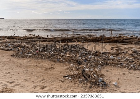 Mountains of waste and garbage on the sandy beach after the tide. Humanity is polluting the ocean.