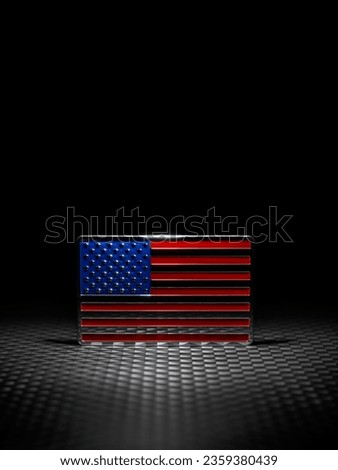 Spotlight on shiny US American flag emblem on dark carbon fiber. Symbolizing USA strength, Memorial day, Veteran's day, or other patriotic event. Royalty-Free Stock Photo #2359380439