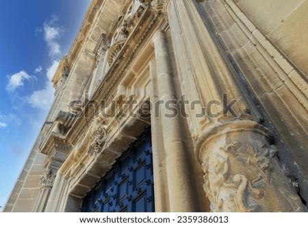 Enhance your creative projects with this captivating, high-quality stock photograph capturing the majestic entrance of the Church of San Juan Bautista in Laguardia, Vitoria. 
