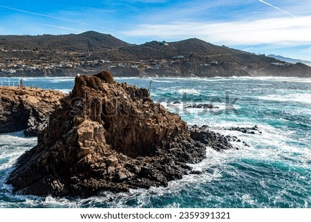 Photograph of an islet in La Bufadora which is a marine geyser in Ensenada in the state of Baja California in Mexico, is a very touristy place and visited by people.