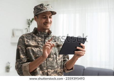 Male soldier using tablet computer on white background. Military service
