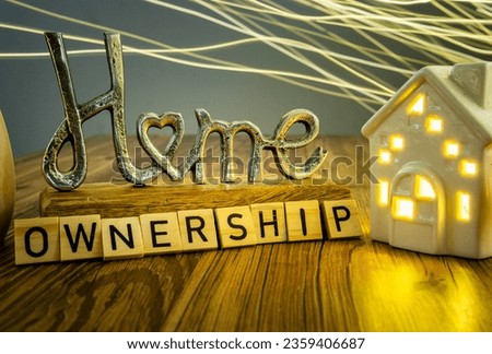 home ownership sign ceramic house with bright wavy light on in the background