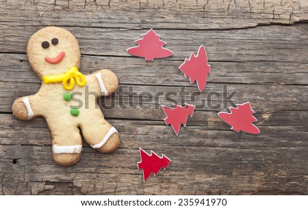 homemade christmas painted ginger-breads (gingerbread man) on the wooden background 