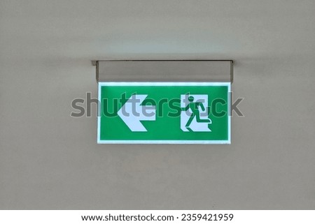 Exit Sign Hanging on the Ceiling.