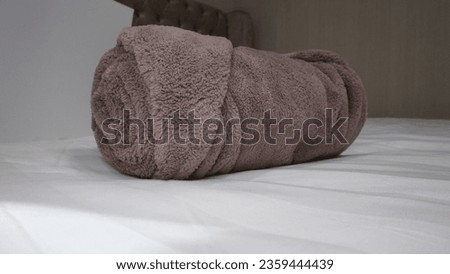luxury hotel quality shower bath room towel in roll shape size on bed product photo shoot display ib blue white brown color