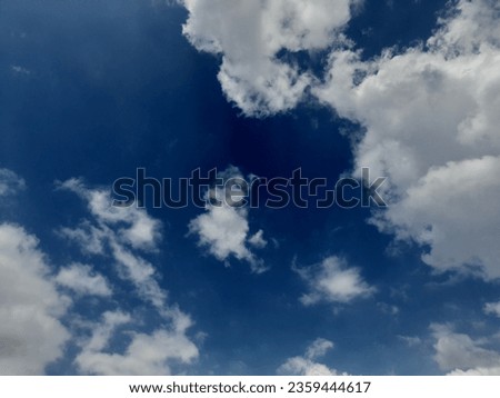 Beautiful white clouds on deep blue sky background. Large bright soft fluffy clouds are cover the entire blue sky. Skyscape on Lombok Island, Indonesia