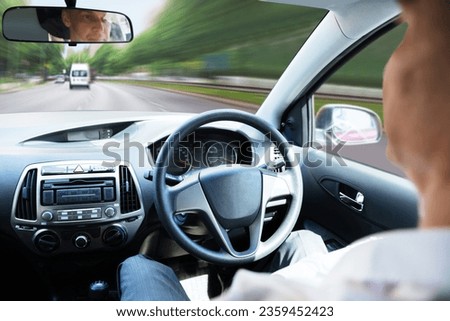 Close-up Of A Man Sitting In Self Driving Car Royalty-Free Stock Photo #2359452423