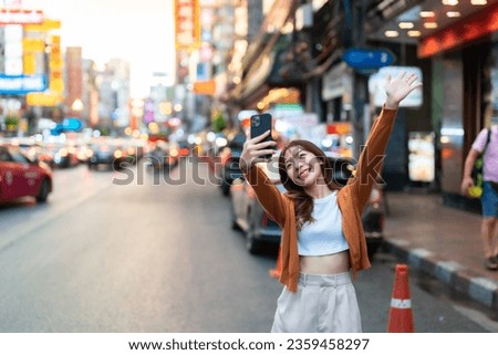 Young Asian tourists standing selfie taking a photo. Young woman beautiful tourists in Chinatown street food market, Bangkok, Thailand Royalty-Free Stock Photo #2359458297