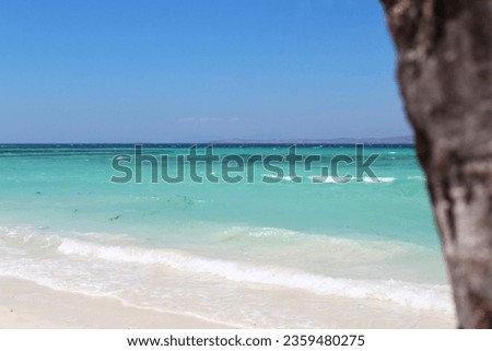 Scenic White Sand Beach with Blue Turquoise Sea Water with Clear Blue Sky During A Hot Summer Day