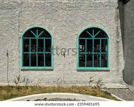 Vintage blue window on white concrete wall