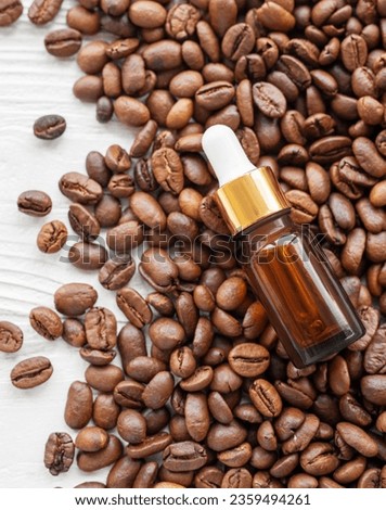 Skincare caffeine eye serum. Product bottle and coffee beans.   Caffeine skincare.  Royalty-Free Stock Photo #2359494261