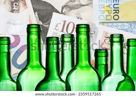 Alcohol price background. Wine bottle excise. Increasing high alcohol tax. British pound, euro and dollar currency. Green wine bottle and paper money bills.