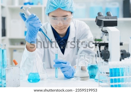adult scientist using pipette dropping liquid samples into test tube analyzing biology pharmacy in laboratory, doctor student working research for technology innovation development in university
