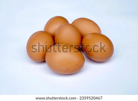 Several chicken eggs lying on a white background It looks striking and natural. Royalty-Free Stock Photo #2359520467