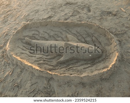 Shark-shaped sand sculpture on the beach of Pinarella di Cervia