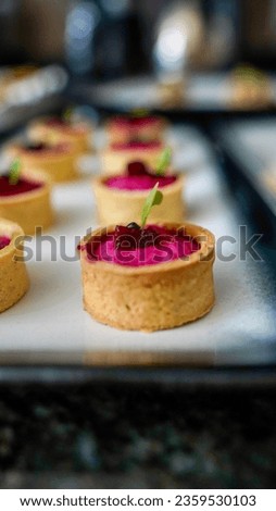 Canapé waiting to be served on white plates featuring beetroot, goats cheese and fried wontons Royalty-Free Stock Photo #2359530103
