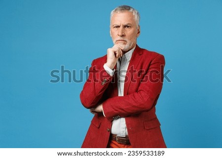 Perplexed pensive concerned elderly gray-haired mustache bearded business man wearing red jacket suit standing put hand on head looking camera isolated on blue color wall background studio portrait Royalty-Free Stock Photo #2359533189