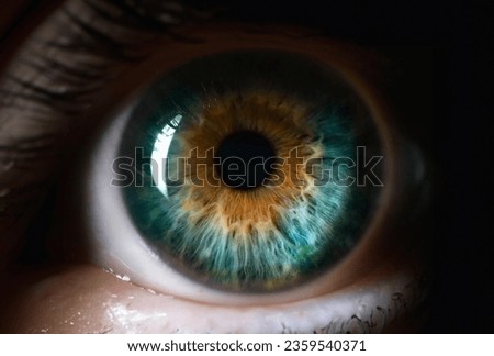 Blue orange human eye close up background. Color perception blindness concept Royalty-Free Stock Photo #2359540371