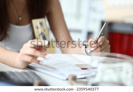 Focus on woman calculating numbers with profits charts in comfortable workplace tender hands of smart businesswoman holding important paper folder. Business concept. Blurred background