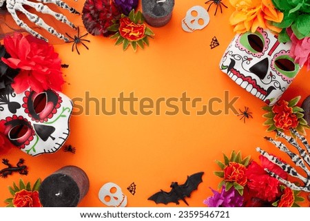 Dance with the Spirits on Dia de los Muertos. Top view photo of decorated skull masks with flowers, candles, skeleton hands, creepy decor on orange background with ad zone