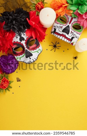 Immerse yourself in the colors and traditions of Dia de los Muertos. Top view vertical shot of carnival masks, flowers, candles, creepy decorations, on yellow background with promo spot