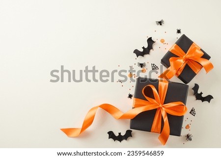 Get your scare on with our Halloween sale. Top view photo of black gift packages, satin bows, bat silhouettes, shiny sparkles on light grey background with advertising zone