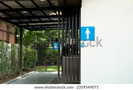 Modern Men's restroom sign symbol in public gas station, Men's restroom icon on white wall and green nature blur background