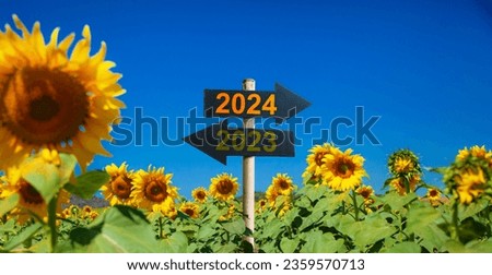 2024  to the right and 2023 to the left.
road signs in the sunflower garden. start to be Successful in the new year.